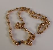 UNOAERRE, A 9CT GOLD FANCY LINK NECKLACE, of alternating fluted oval and plain bead links, import