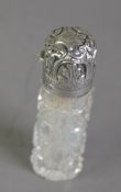 LATE VICTORIAN CUT GLASS SCENT BOTTLE WITH EMBOSSED SILVER LID, of cylindrical form with leaf and