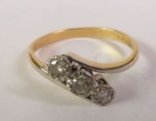 THREE STONE DIAMOND CROSSOVER RING, graduated round-cut diamonds in illusion settings to crossover