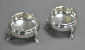 PAIR OF EARLY GEORGE III SILVER CAULDRON-SHAPE SALT-CELLARS with cabled rims, each on three