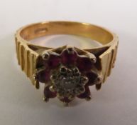 9ct GOLD BROAD TEXTURED CLUSTER RING, set with a centre tiny diamond and surround of tiny rubies,