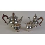 MATCHED FOUR PIECE GEORGIAN STYLE PLAIN SILVER TEASET, of footed bellied form with brown scroll