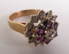 9ct GOLD THREE TIER DAISY CLUSTER RING, set with six tiny rubies and 13 tiny diamonds