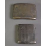TWO GEORGE V ENGINE TURNED SILVER POCKET CIGARETTE CASES, each of curved oblong form with