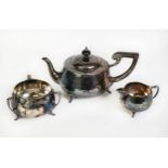 GEORGE V ART DECO PLANISHED SILVER THREE PIECE TEASET BY THE BARKER BROTHERS, of circular bellied