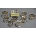 EIGHT VARIOUS SILVER NAPKIN RINGS, some marks rubbed, 4oz all in. Together with THREE WHITE METAL