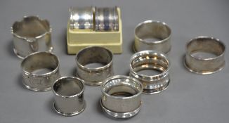 EIGHT VARIOUS SILVER NAPKIN RINGS, some marks rubbed, 4oz all in. Together with THREE WHITE METAL