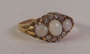 EDWARDIAN 18CT GOLD OPAL AND DIAMOND CLUSTER RING, three graduated opals within a border of old-