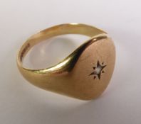 9ct GOLD SIGNET RING, with a tiny diamond in a star setting, ring size ‘U’, 4.2gms
