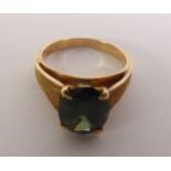 GREEN COLOUR CHANGE SAPPHIRE RING, an oval-cut sapphire to textured angular shoulders, marked ‘750’,