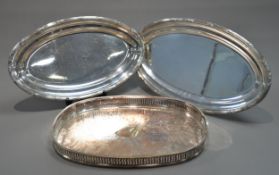 SILVER PLATED ON COPPER TWO HANDLED GALLERIED TRAY, of rounded oblong form with cut-out handles,