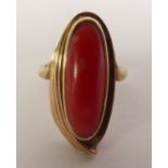 RED CORAL DRESS RING, an oval coral in a fancy fluted frame, ring size J, 4.8g