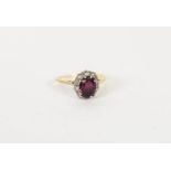 18ct GOLD RUBY AND DIAMOND OVAL CLUSTER RING, set with a centre oval ruby and surround of ten