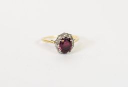 18ct GOLD RUBY AND DIAMOND OVAL CLUSTER RING, set with a centre oval ruby and surround of ten