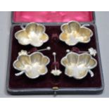 CASED SET OF FOUR LATE VICTORIAN SILVER CLOVER-LEAF SHAPE SALT-CELLARS with MATCHING SPOONS (one