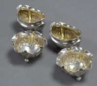 PAIR OF EARLY TWENTIETH CENTURY SILVER OVAL DEMI-GADROONED SALT-CELLARS, with gilded interiors,