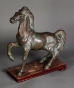 ORIENTAL ANTIQUE STYLE PATINATED BRONZE MODEL OF A HORSE, modelled with front right leg raised,