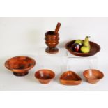 OLIVE WOOD PEDESTAL PESTLE AND MORTAR, together with FOUR TURNED WOOD BOWLS, one stamped for