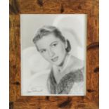 JOAN FONTAINE, SIGNED BLACK AND WHITE PROMOTIONAL PHOTOGRAPH, bust portrait, facing left, 9 ½” x