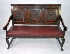 19th CENTURY OAK SETTLE WITH THREE PANEL BACK, cave relievo with foliate scrolls, the upholstered
