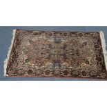 PERSIAN RUG, the centre medallion with small pendants on a brown and floral field, cream spandrels
