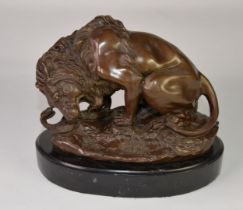 POST-WAR BRONZE REPLICA MODEL OF A LION and a SNAKE, on an OVAL BLACK MARBLE BASE, 9 ½" (24cm) high,
