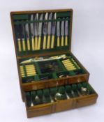 ART DECO OAK TABLE TOP CANTEEN, with an electroplat table service of Early English pattern CUTLERY