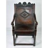 PERIOD OAK: Late 17th/early 18th century oak panel arm chair with relief carved triffid top rail and