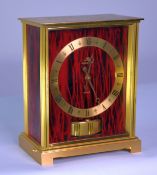 JAEGER LE COULTRE ‘EMBASSY’ ATMOS CLOCK, the 5” gilt Roman chapter ring set on a streaky red and