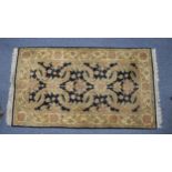EASTERN RUG, the black field having large floral and foliate scroll repeat pattern in pale green and