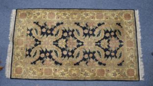 EASTERN RUG, the black field having large floral and foliate scroll repeat pattern in pale green and