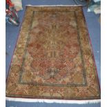 PROBABLY KASHMIR, FINELY HAND KNOTTED ALL-SILK CARPET IN KIRMAN STYLE, with two concentric lobed and