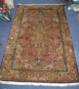 PROBABLY KASHMIR, FINELY HAND KNOTTED ALL-SILK CARPET IN KIRMAN STYLE, with two concentric lobed and