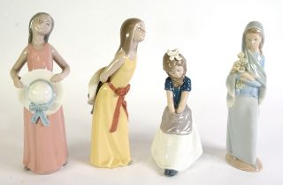 FOUR LLADRO PORCELAIN YOUNG FEMALE FIGURES, viz a girl seated with her hands in her apron, two