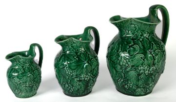 SET OF THREE 20th CENTURY WEDGWOOD GREEN GLAZED GRADUATED OVULAR JUGS, embossed all-over with fruiT