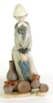 LLADRO PROCELAIN FIGURE of a young woman with folded umbrella selling bisque pots 11 3/4" (30cm)
