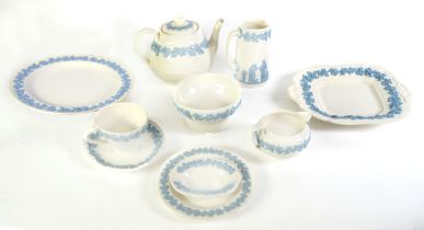 WEDGWOOD EMBOSSED PALE BLUE ON WHITE QUEEN'S WARE POTTERY DINNER AND TEA SERVICE for nine persons,