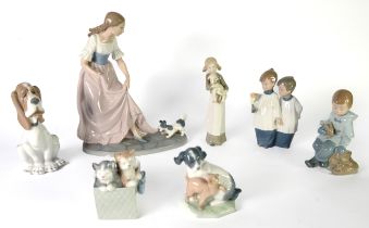 LARGE NAO PORCELAIN GROUP, puppy dog pulling on an elegant lady's long skirt, on oval base, 11 3/4in