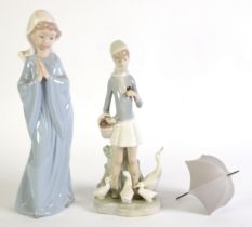 LLADRO PORCELAIN FIGURE OF A GIRL carrying an open umbrella with a family of geese at her feet 9 1/