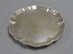 VICTORIAN ENGRAVED SILVER SALVER, of typical form with claw and ball feet, the centre decorated with