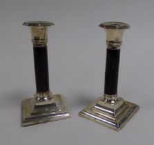 PAIR OF INTER-WAR YEARS WEIGHTED SILVER and TORTOISESHELL CANDLESTICKS, on square bases,