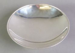 GEORGE VI PLAIN SILVER FOOTED DISH, of shallow form with beaded border, 2 ¼” (5.7cm) high, 8” (20.