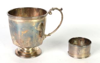 GEORGE V PLAIN SILVER CHILD’S CHRISTENING MUG, of footed form with panelled lower body and high