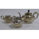 THREE PIECE CHINESE EMBOSSED SILVER COLOURED METAL TEA SET, of compressed, footed form with bamboo