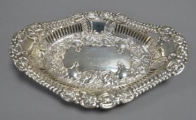 EDWARD VII PIERCED AND EMBOSSED SILVER PRESENTATION TWO HANDLED DISH, of lozenge form, with slot