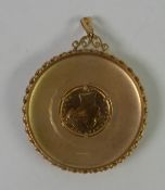 9ct GOLD LARGE, SLIGHTLY DOMED CIRCULAR PENDANT, bark textured with spirally twist applied edge, the