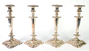 SET OF FOUR 19th CENTURY SILVER ON COPPER TABLE CANDLESTICKS, with campana shaped sconces with