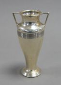 GEORGE V TWO HANDLED WEIGHTED SILVER VASE, of tapering from with angular handles and reeded borders,