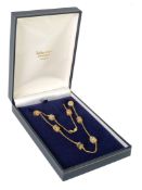 18CT GOLD FINE CHAIN NECKLACE WITH 8 REEL SHAPED DIVIDERS each set with girdle of different coloured