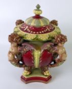 GEORGE JONES & SONS MAJOLICA VASE AND COVER CENTREPIECE with winged caryatids with paw feet,